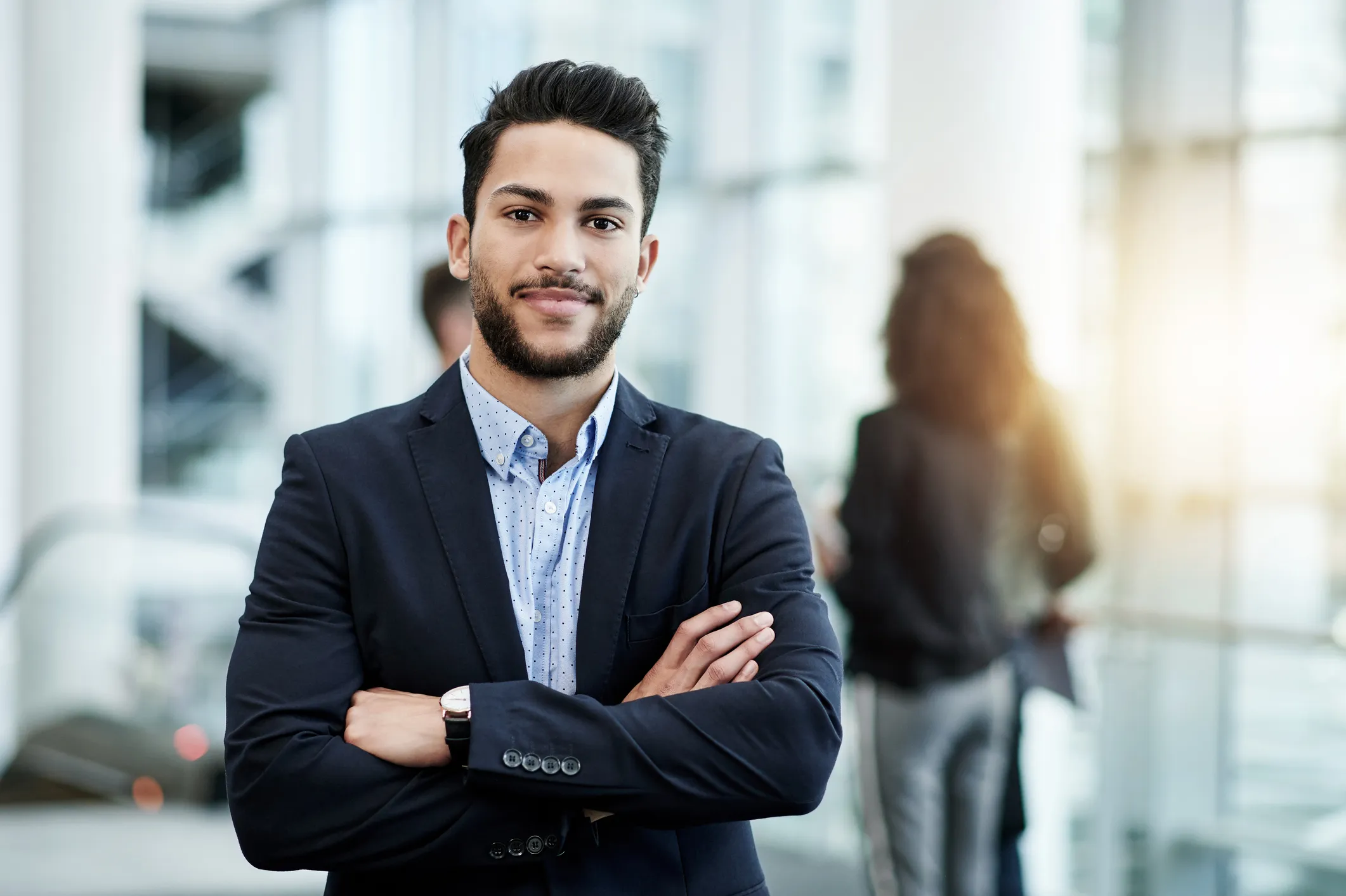 male professional with arms crossed posing for photo