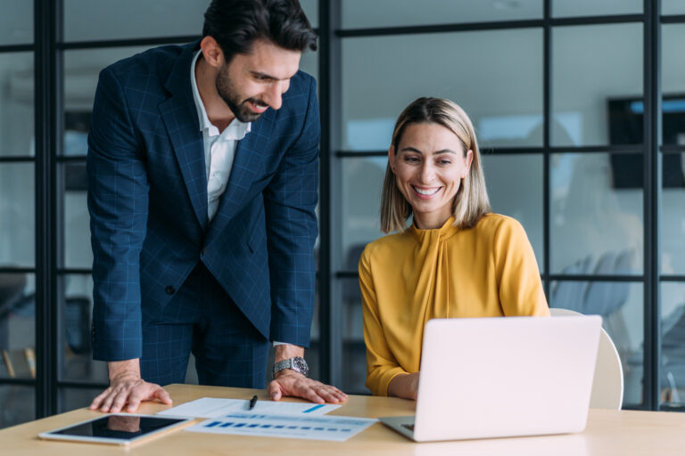 male and female colleagues discuss documents