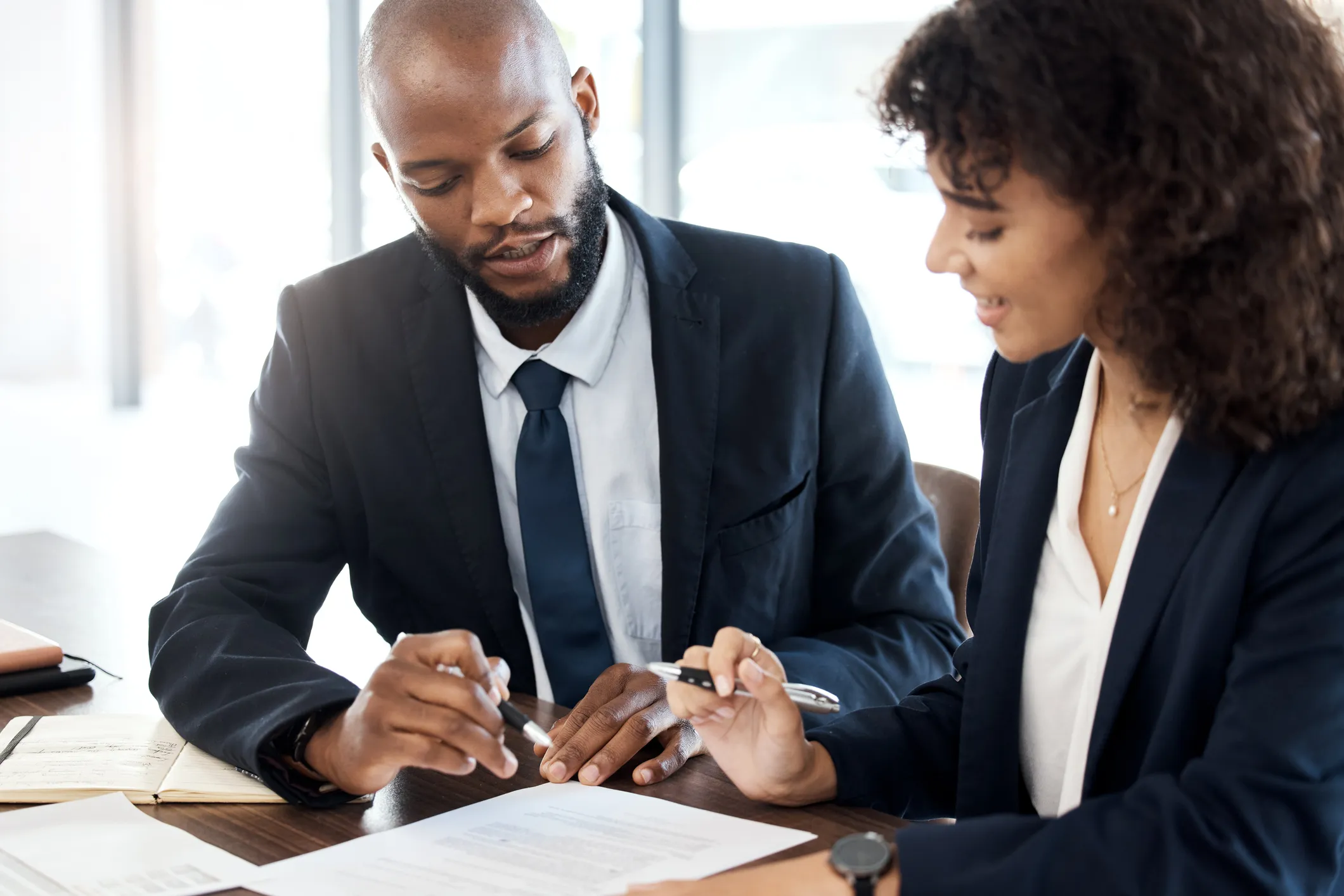two professionals discuss a document