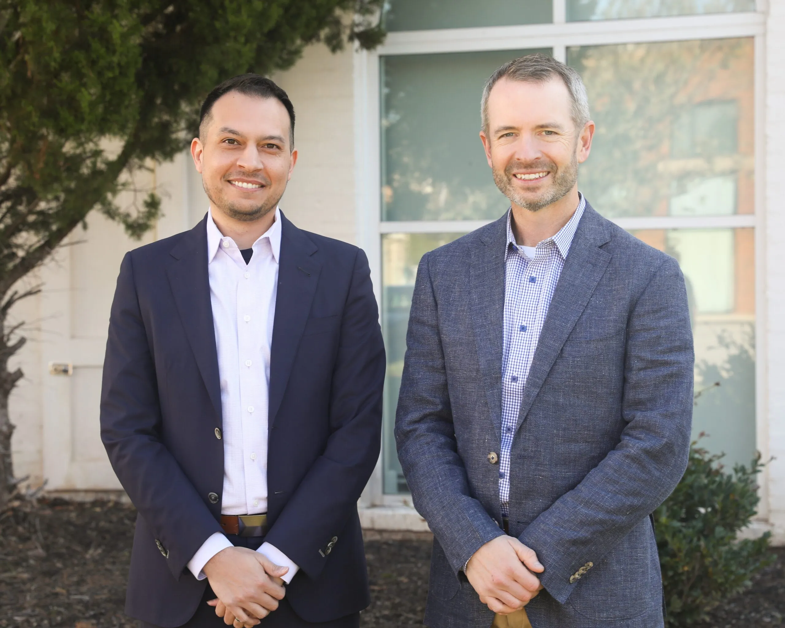 two professional colleagues pose for a photo