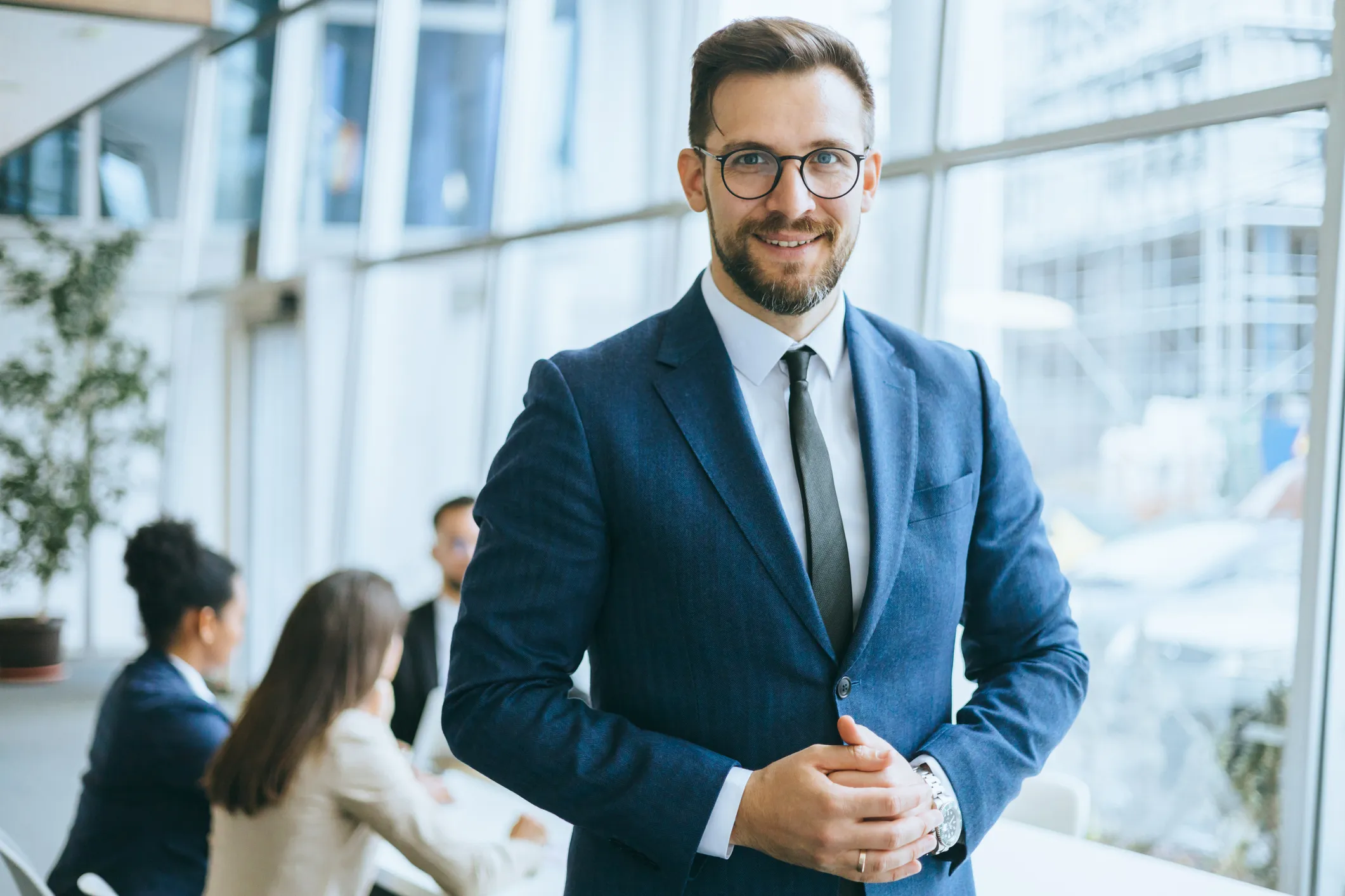 smiling male professional poses for photo