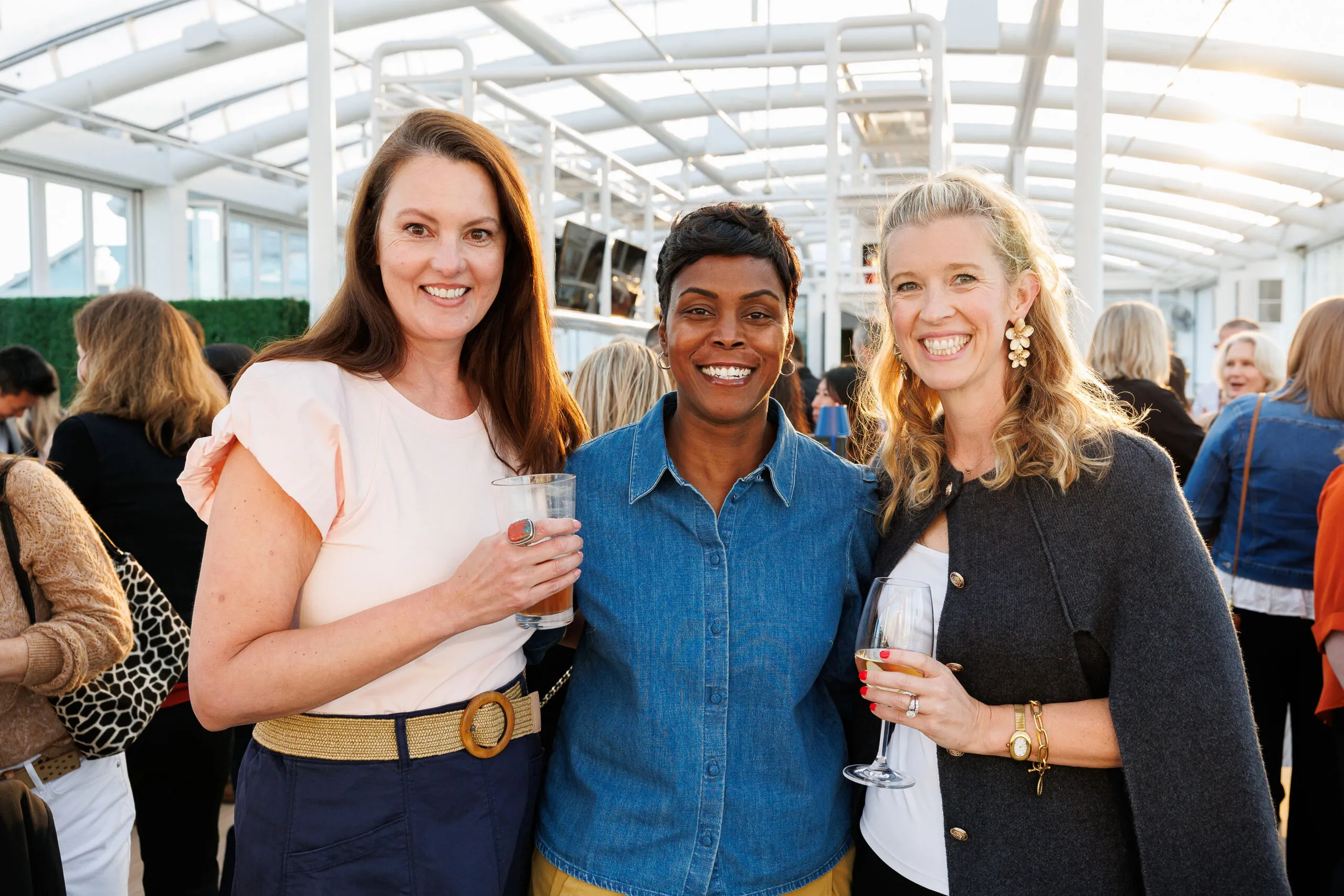3 businesswomen pose for camera