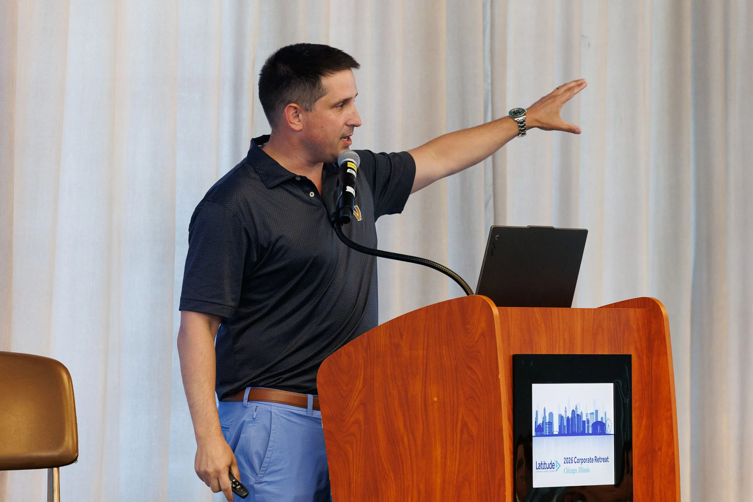 Latitude Tampa Market Leader, Kyle Robisch, speaking on stage.