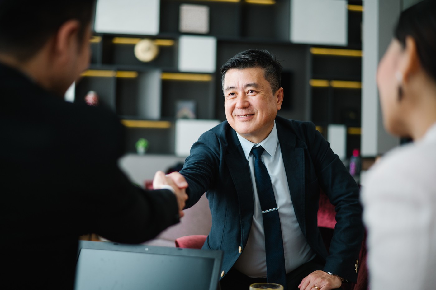 Shot of two businessmen shaking hands in an office