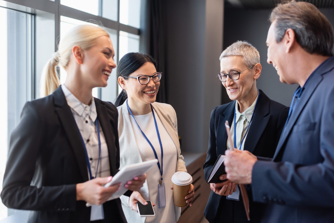 Cheerful group of business people chatting in office