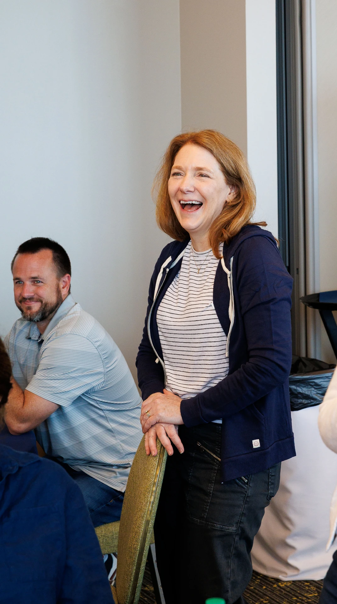 Woman standing up laughing