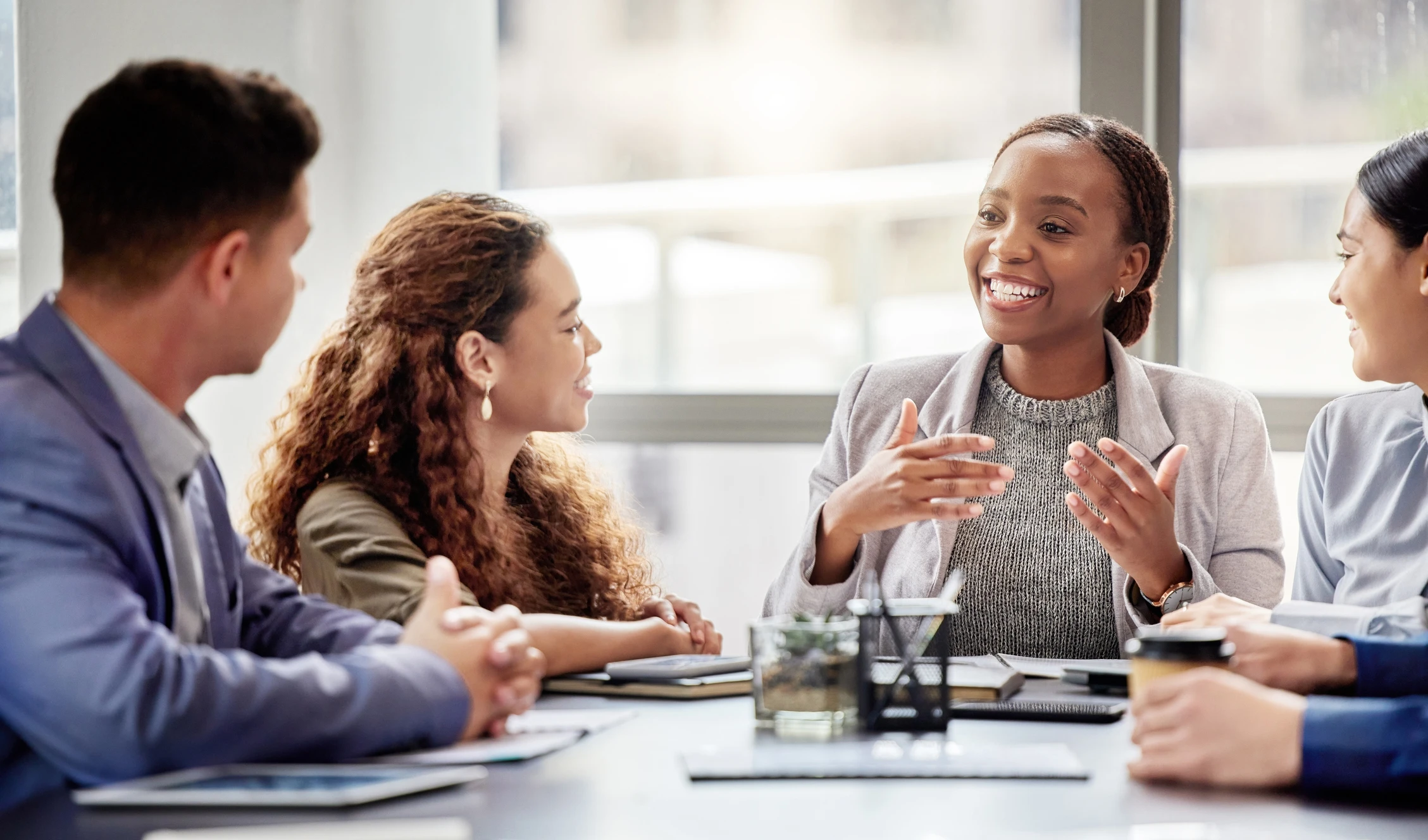Woman talking to colleagues at conference table