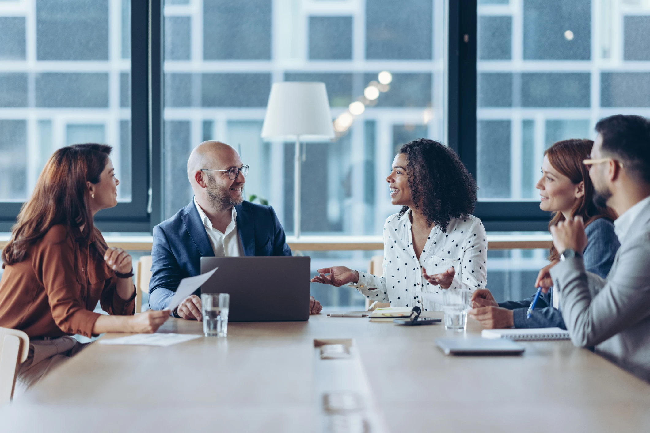 Group of business professionals working at a conference table.