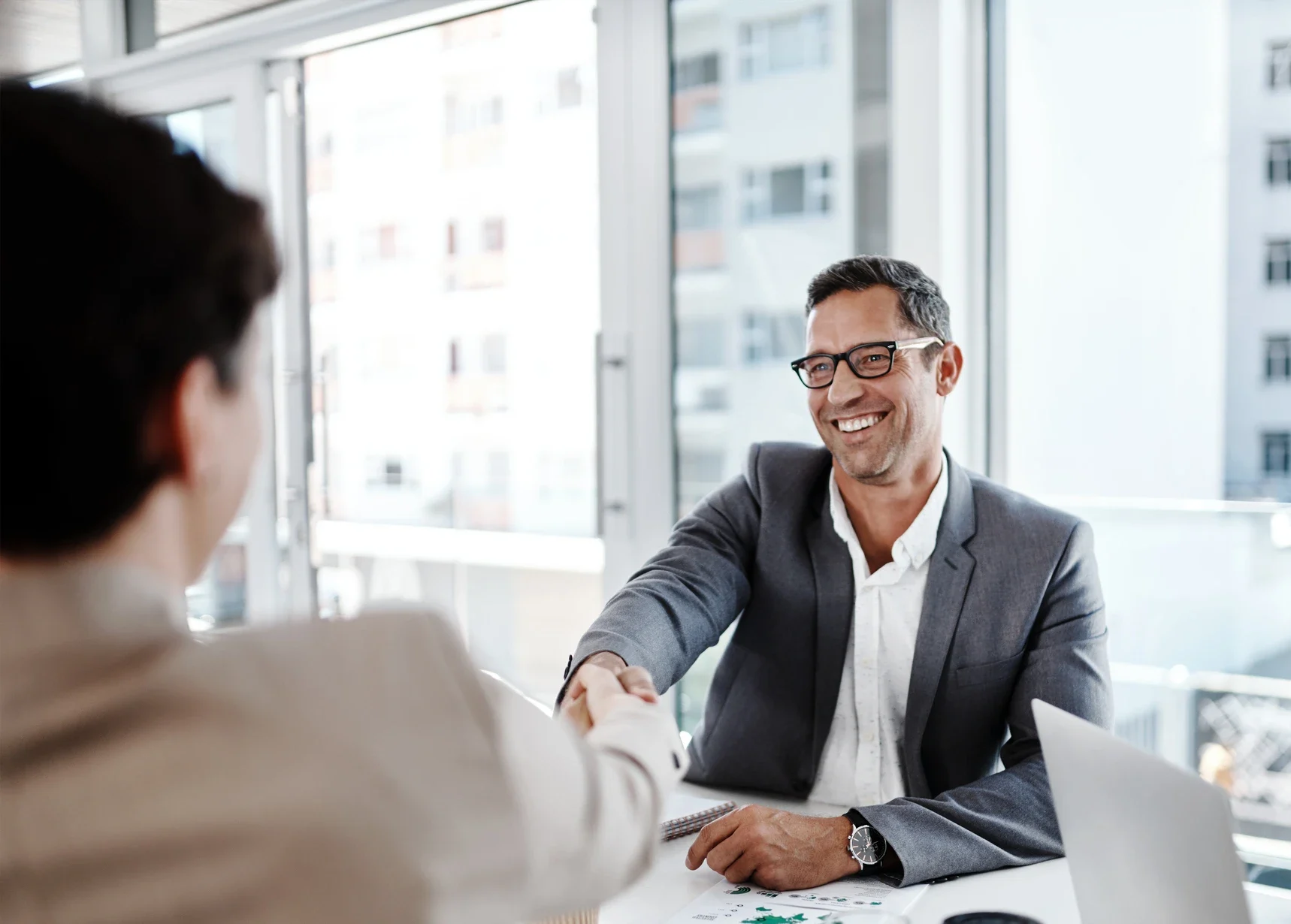 Shot of businesspeople shaking hands in an office